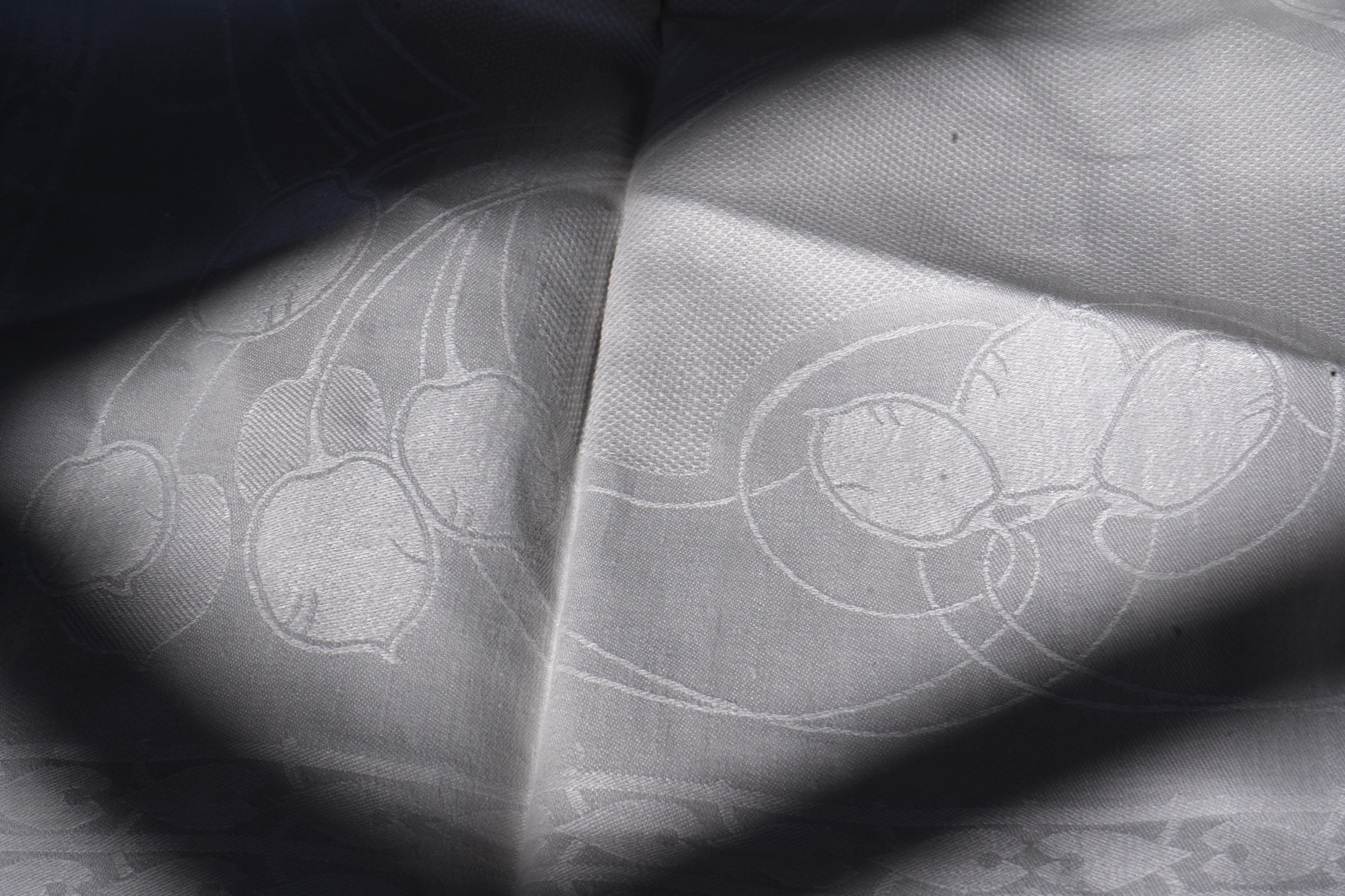 A set of four large Art Nouveau, unused white damask woven hand towels. The pattern having strong Archibald Knox and Walter Crane design elements; with trailing Honesty seeds and Tulip flower heads, these motifs much use